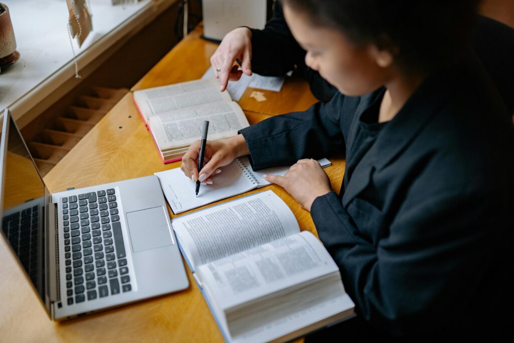 Student studying with books and laptop in a quiet environment