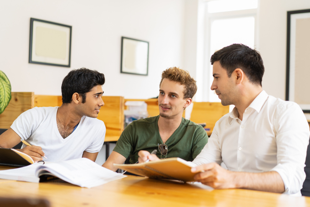 Students debating in a classroom setting, or reading a case study.